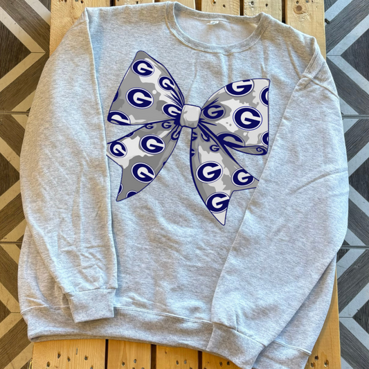 Ash crewneck sweatshirt with bow covered in the Greenwood G pendant.